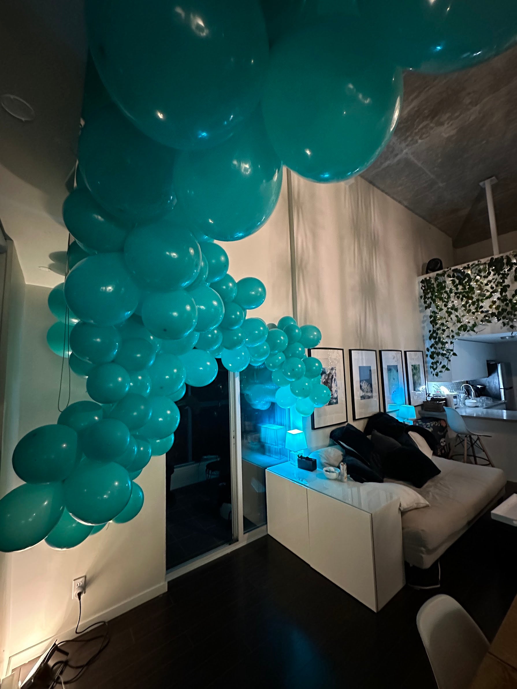 Turquoise balloon arch in a living room with modern decor