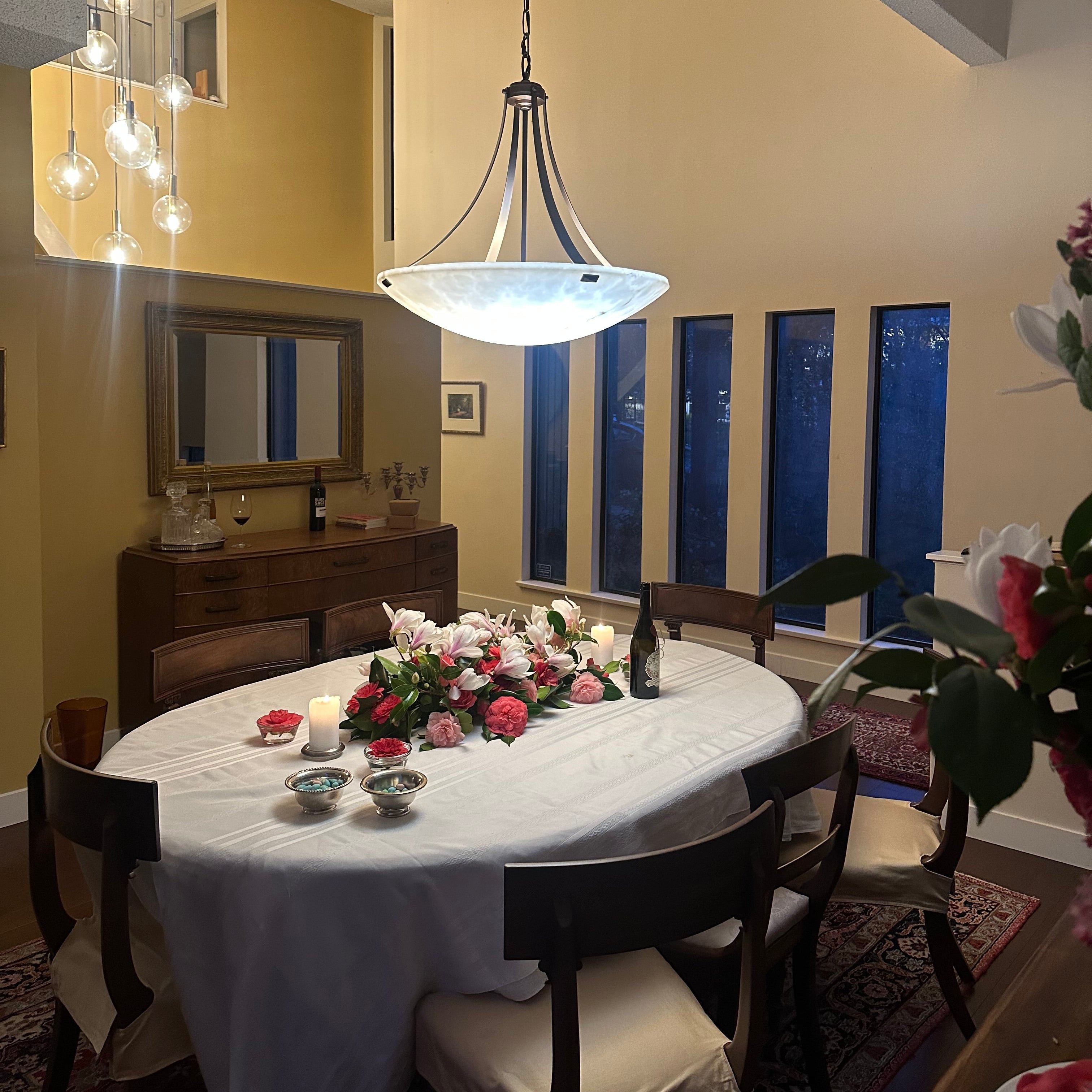 Dining room with a round table, chairs, and decorative elements.