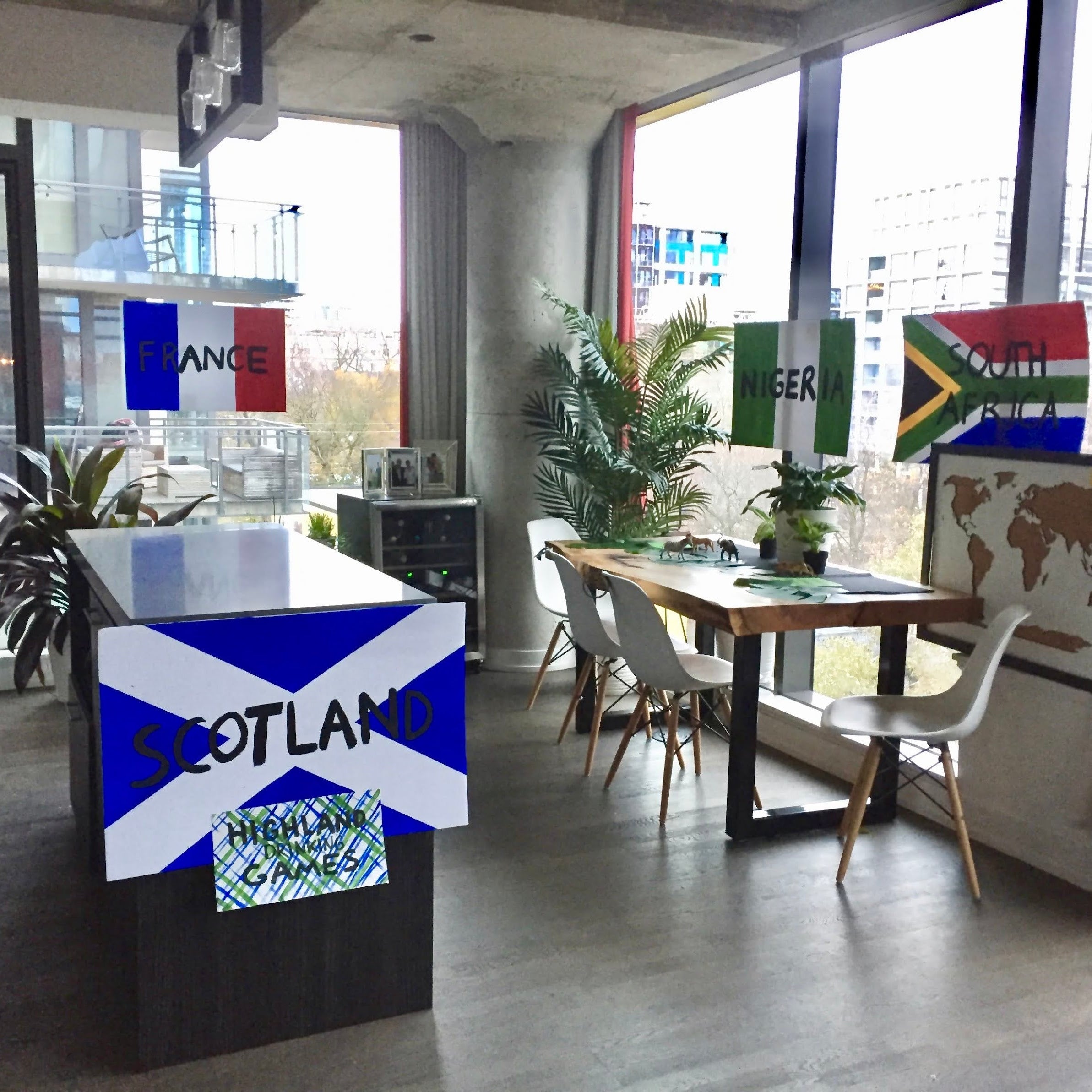 Modern office space with a desk featuring a Scotland flag design, surrounded by windows.