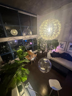 Modern living room with decorative spherical lights and plants.