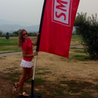 evelyn martin holding a red Smirnoff flag outdoors